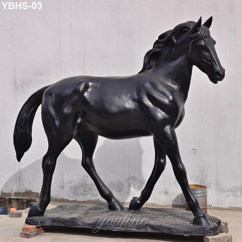 Elegant black bronze horse statue standing on a textured base with detailed facial features and muscular body design.