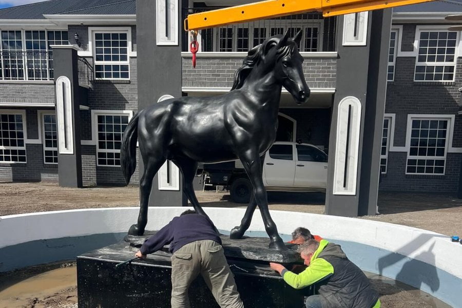 Bronze standing horse sculpture at estate entrance