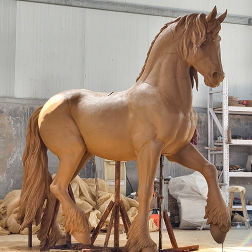 Hand-crafted clay model of a bronze horse sculpture in progress