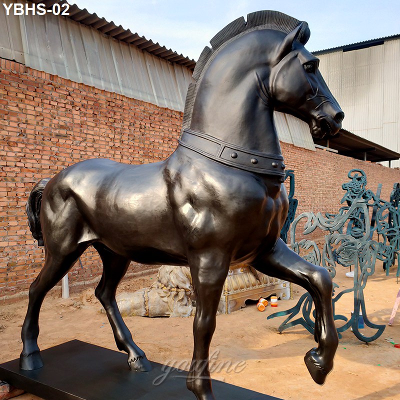 life size bronze horse sculpture with a raised leg, polished finish, and detailed mane, displayed outdoors