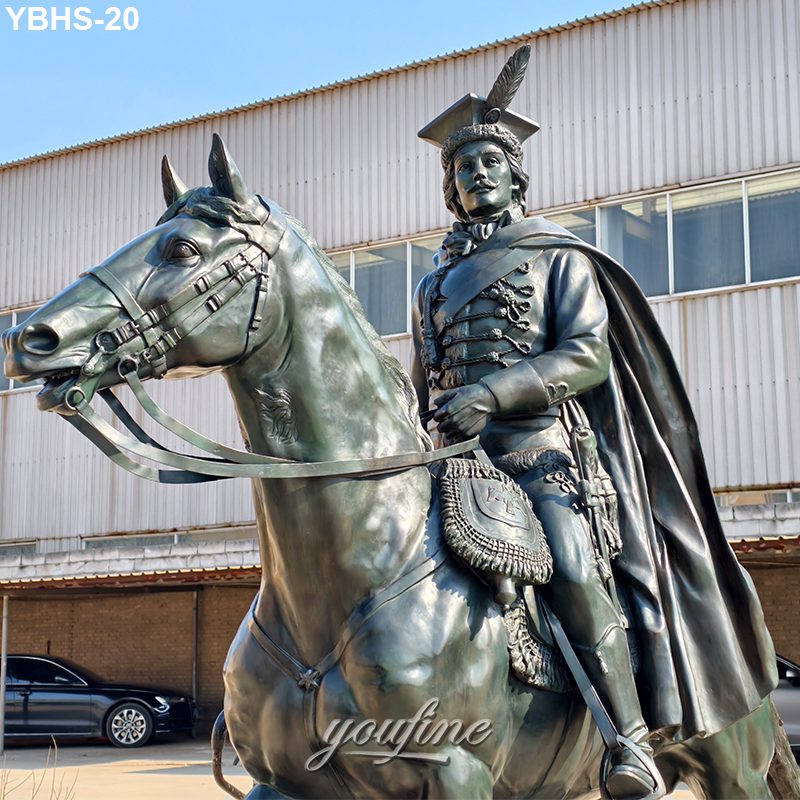 Bronze equestrian sculpture of a figure in military attire on horseback, featuring intricate details and displayed outdoors.