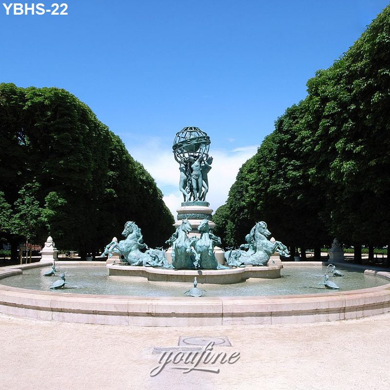 Large decorative bronze fountain featuring sculpted horses and human figures in a symmetrical garden surrounded by trees.