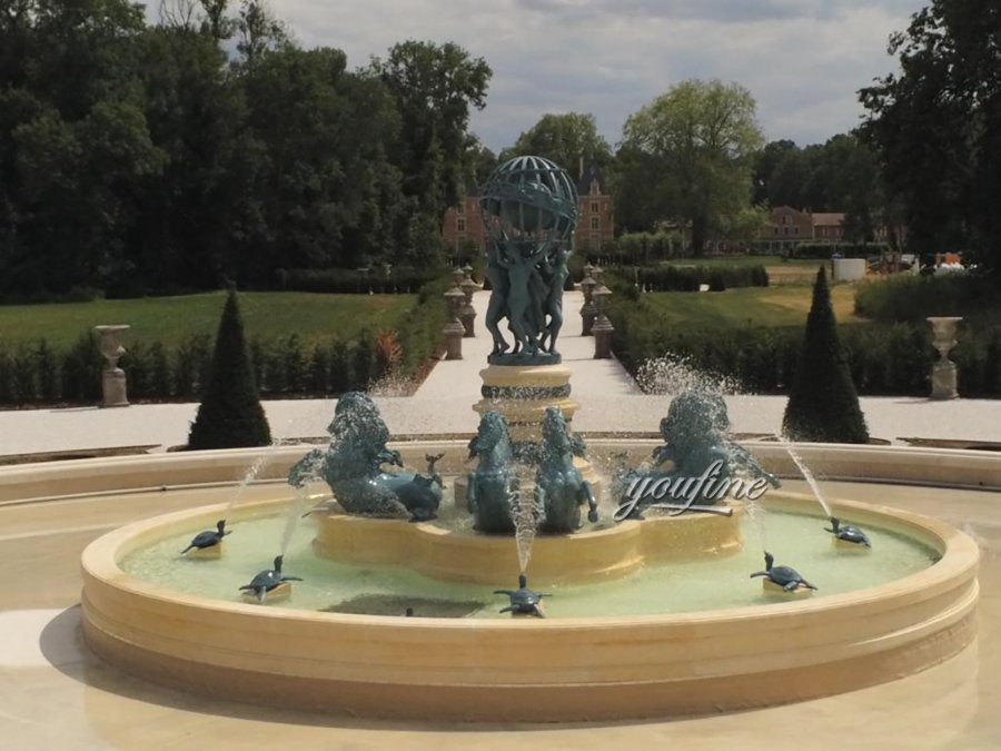 Elegant bronze fountain featuring horses, turtles, and figures supporting a decorative globe in an estate garden setting.