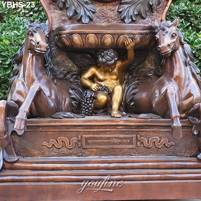Detailed bronze fountain featuring two horses and a cherub holding grapes, with intricate carvings and foliage in the background.