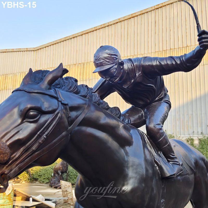 A bronze sculpture of a jockey riding a horse at full gallop, holding a whip, set against an industrial background.
