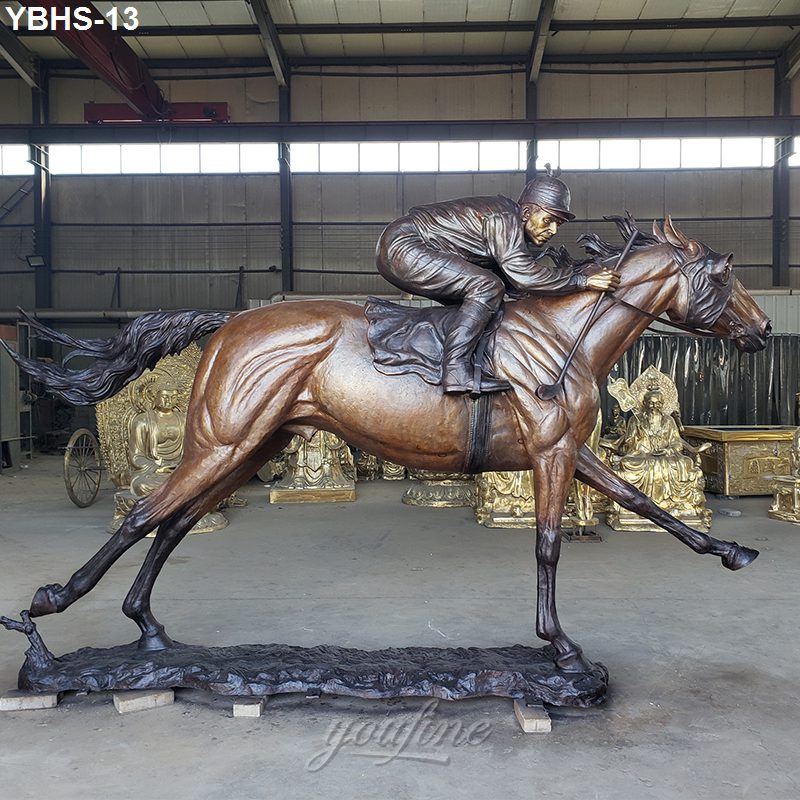 Detailed bronze sculpture of a jockey on a galloping horse in a dynamic racing pose, displayed indoors against a warehouse backdrop.