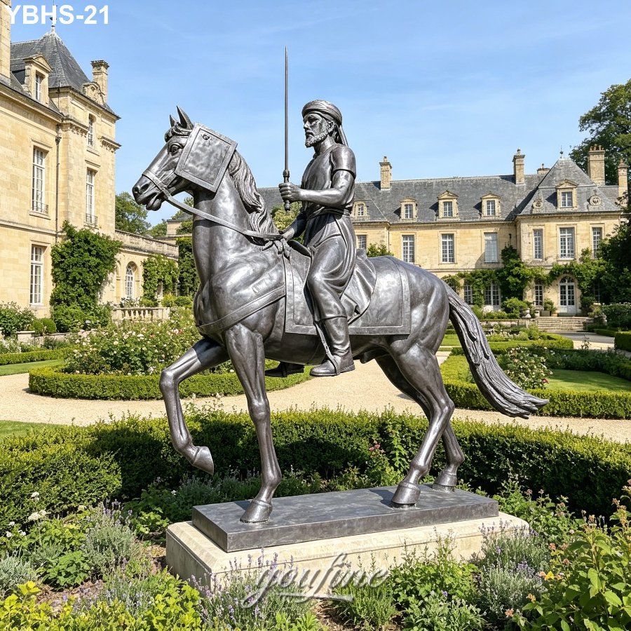 A regal bronze horse statue with a rider holding a sword, displayed in a formal garden near a grand castle-like building.