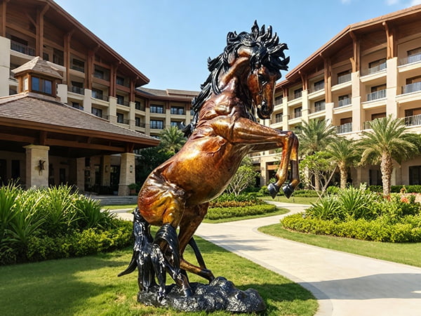 monumental bronze rearing horse sculpture at luxury hotel resort entrance