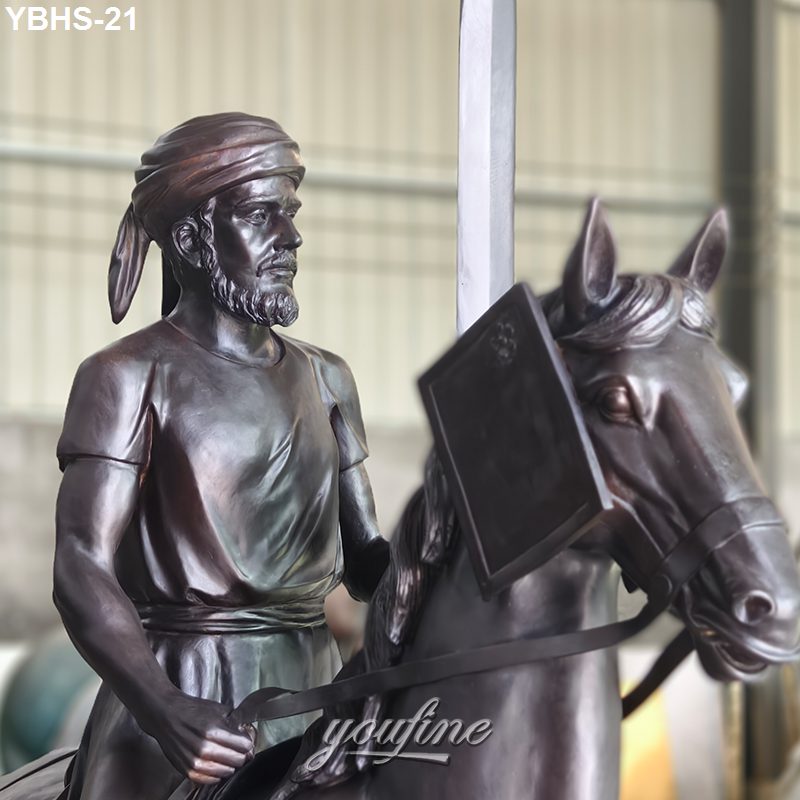Close-up of a bronze sculpture depicting a horseman with a sword, wearing a headscarf and realistic armor detail on the horse.