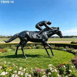 Bronze sculpture of a jockey riding a horse, set in a well-maintained garden with colorful flowers and a racetrack in the background.