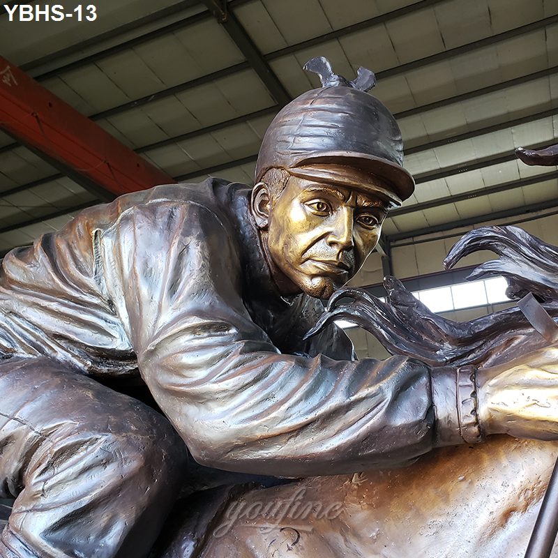 Detailed bronze sculpture of a jockey leaning forward on a galloping horse, positioned in an indoor workspace.