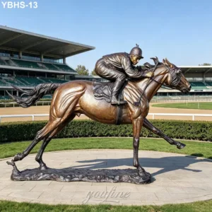 Bronze statue depicting a jockey riding a racehorse in dynamic motion, displayed at a racecourse with grandstand in the background.