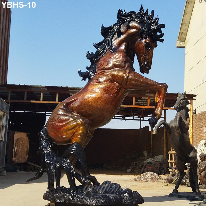 Bronze horse sculpture with intricate details and rearing pose displayed outdoors on a sunny day, symbolizing strength and heritage.