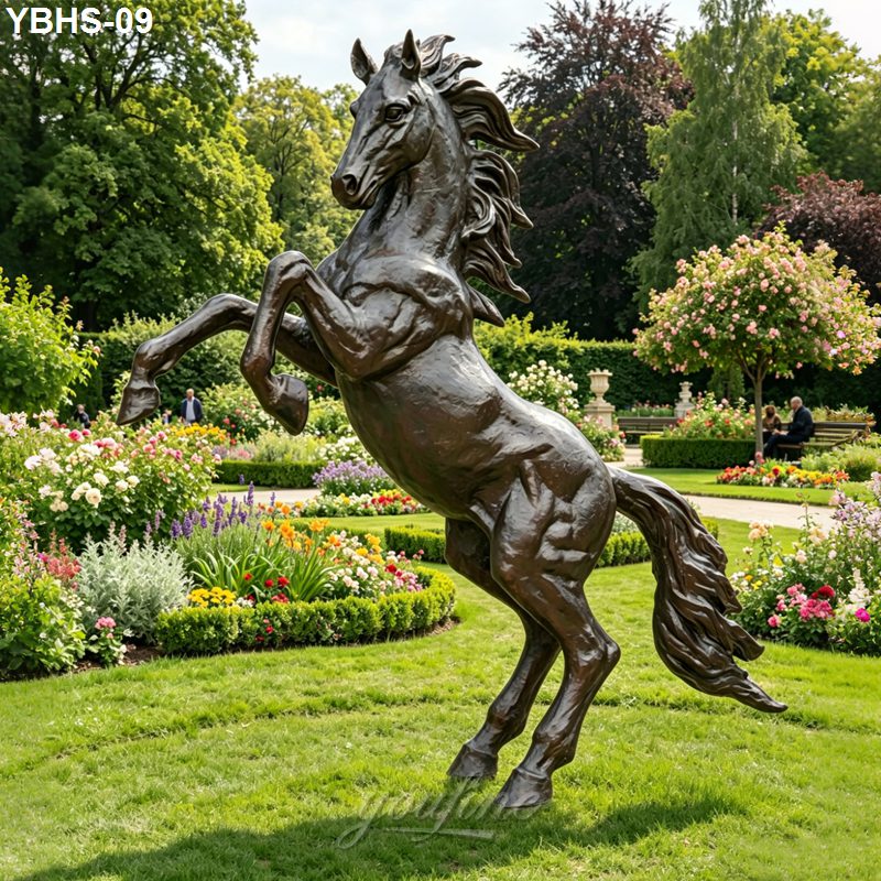 A majestic bronze horse sculpture rearing on its hind legs, set amidst vibrant flower beds and a lush landscaped garden.