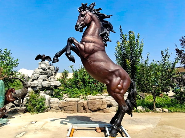 Thorough quality inspection of completed bronze rearing horse sculpture