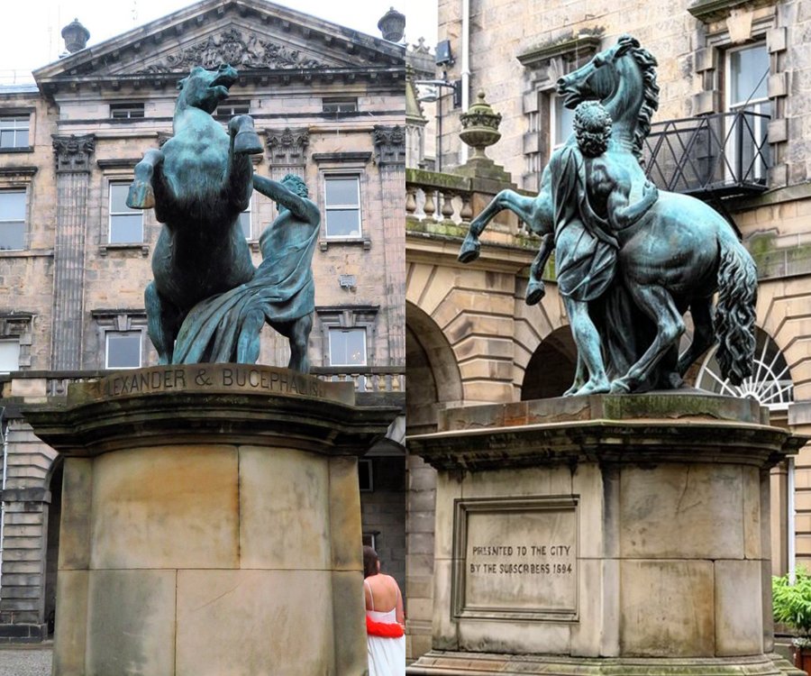 Two bronze statues of Alexander the Great and his horse Bucephalus, set on stone pedestals in a historic stone courtyard setting.