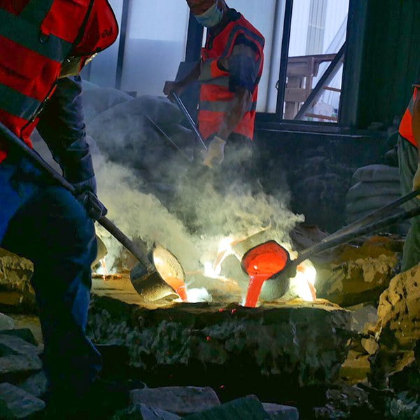 Molten bronze being poured into a ceramic shell