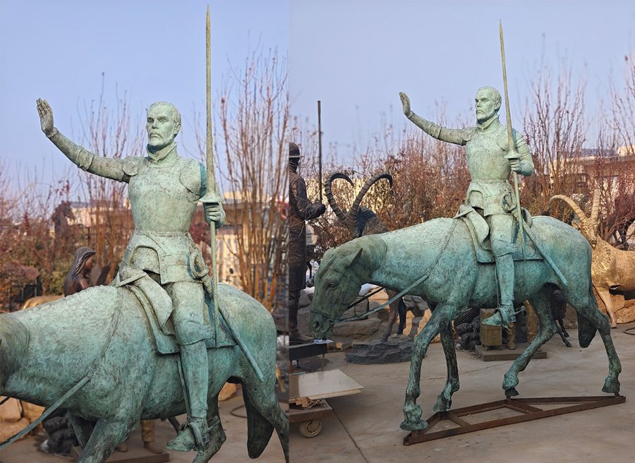 Bronze statue of a mounted knight holding a spear and raising one hand, with detailed armor and a weathered patina finish.