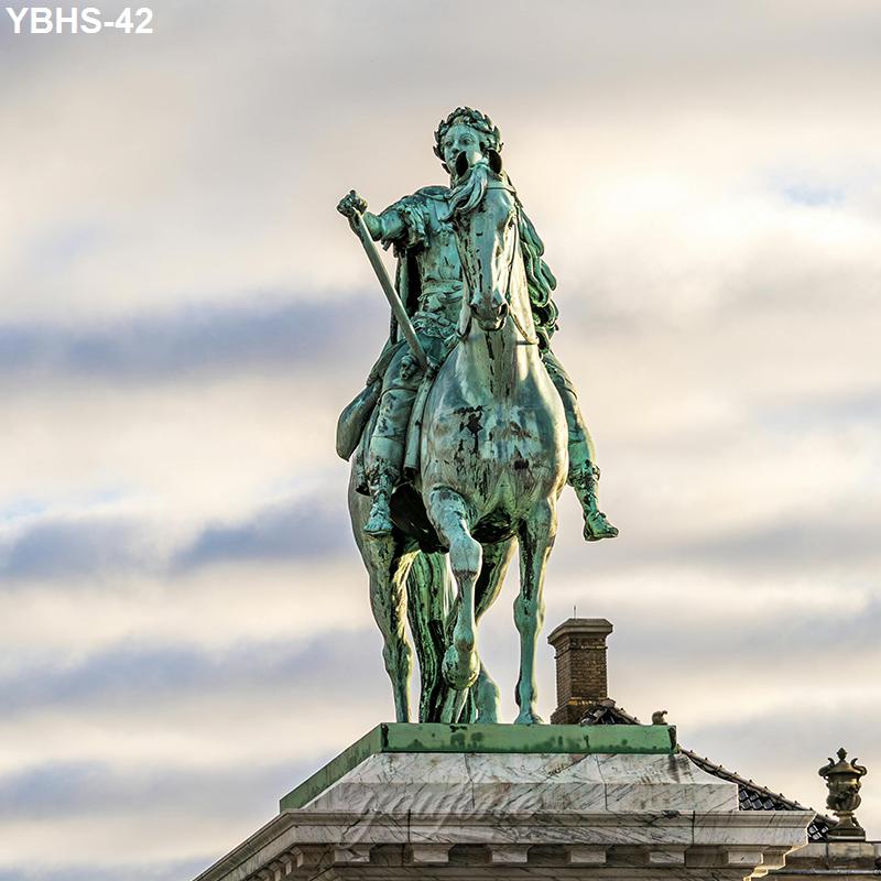 A bronze equestrian statue of a figure on horseback, mounted on a detailed architectural base, with a cloudy sky in the background.