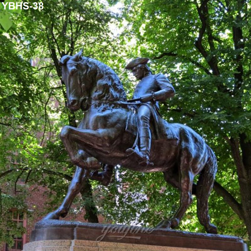 A bronze equestrian statue depicting a mounted figure in historic attire, surrounded by lush green trees in an outdoor park.
