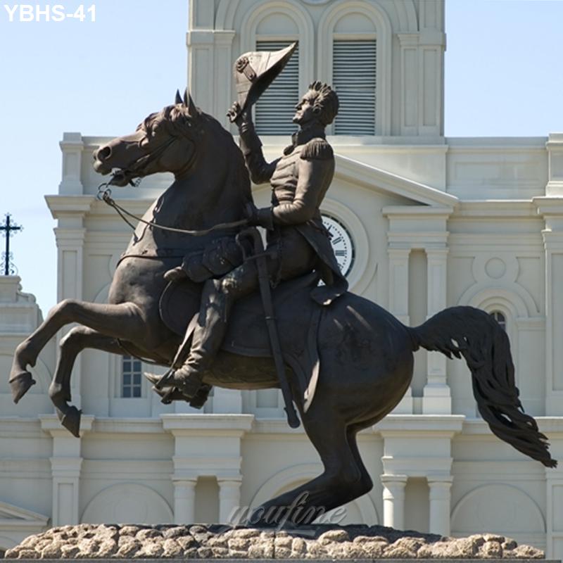 Bronze equestrian statue of a military figure on a rearing horse with a fan, placed in front of a historic building with elegant architecture.