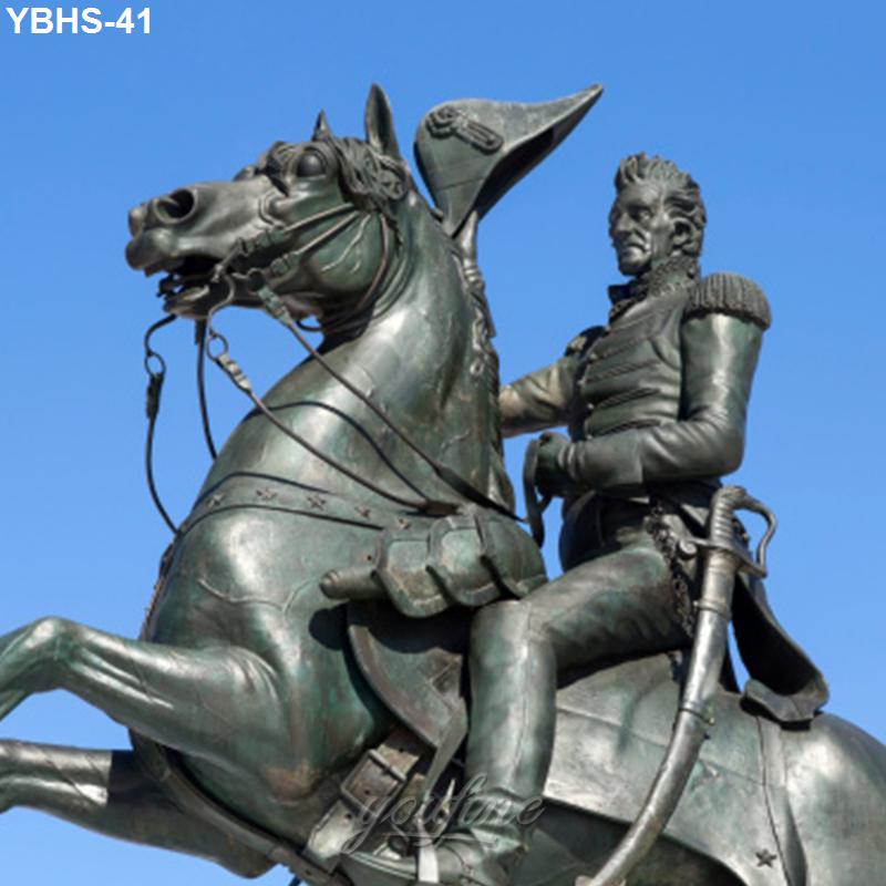 Bronze equestrian statue featuring a detailed horse and historical character in ornate military attire, set against a clear sky.