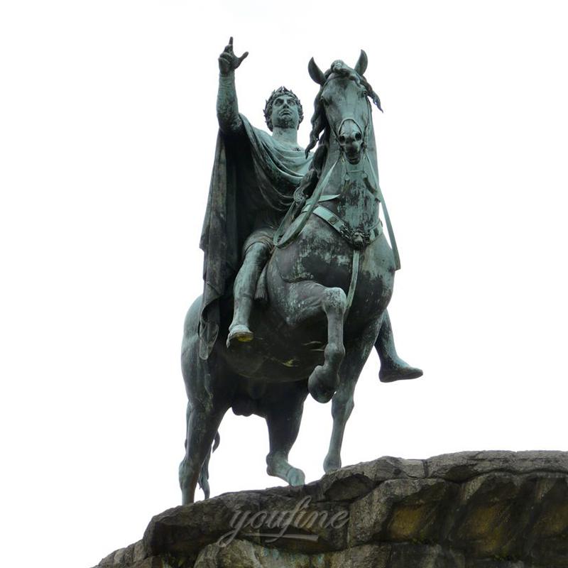 Bronze equestrian statue depicting a mounted figure on a rearing horse atop a stone pedestal against a white background.