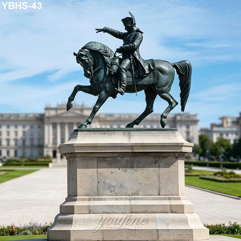 Bronze equestrian statue of a historical figure on horseback pointing outward, mounted on a pedestal in a landscaped plaza.