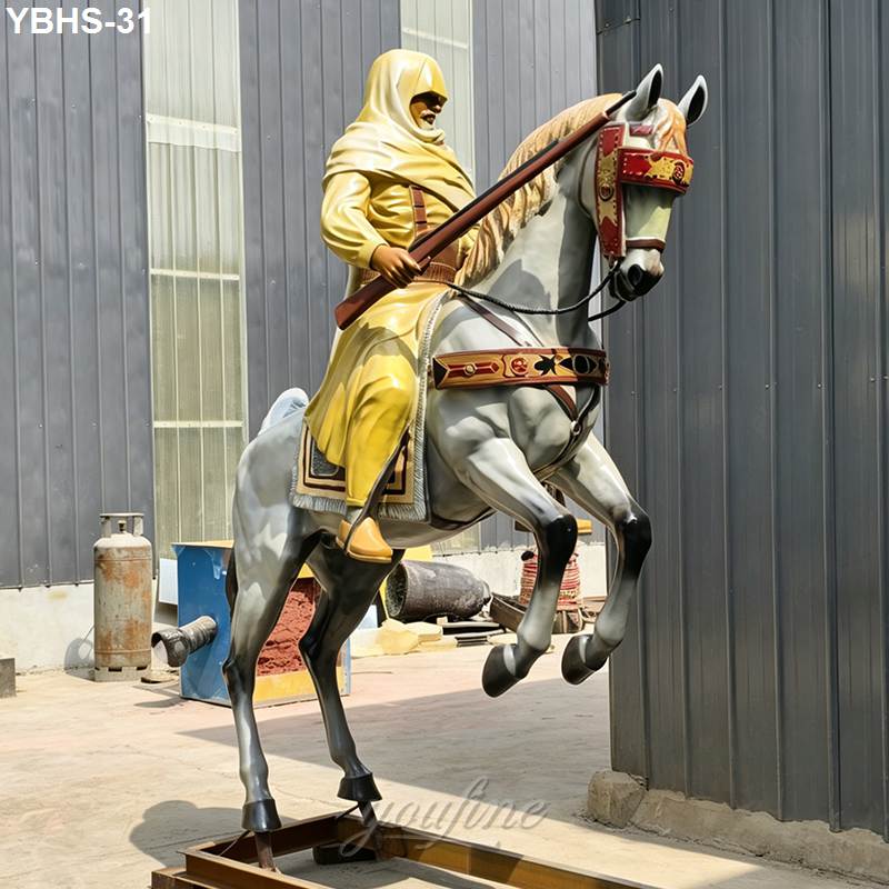 Bronze equestrian statue depicting a warrior in yellow robes riding a rearing horse with intricate saddle and bridle details.