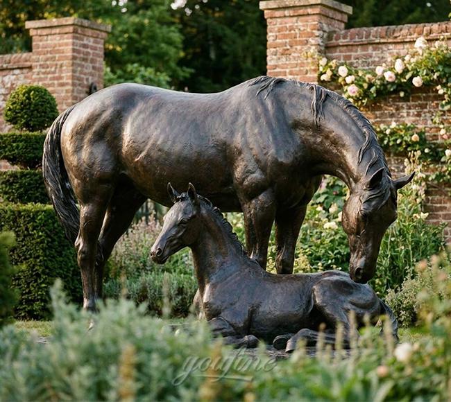Mare and foal bronze sculpture at a private estate walled garden entrance, United Kingdom