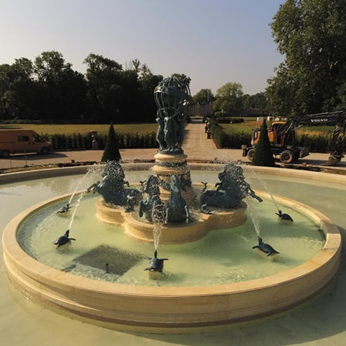 A bronze horse fountain, installed by the client and currently spraying water.