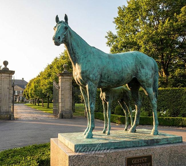 Bronze horse entrance landmark sculpture at an equestrian club in Germany, verdigris green finish on granite base