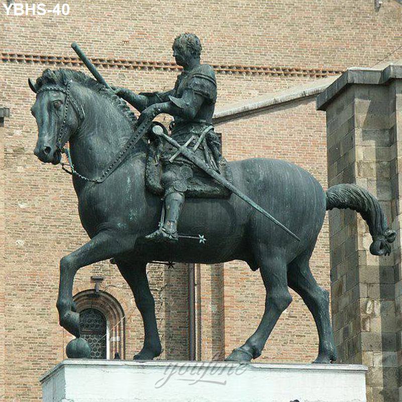 Bronze equestrian statue depicting a horseman holding a sword, mounted on a horse with detailed reins and armor, in front of a brick structure.