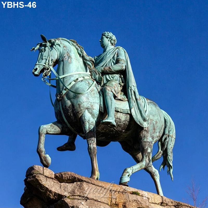 A large bronze equestrian statue of a historical figure on a rearing horse, mounted on a stone pedestal against a clear blue sky.