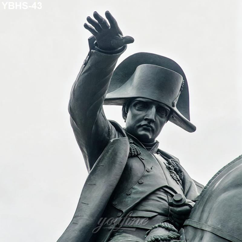 Close-up view of a bronze horseman statue featuring a figure wearing a historical uniform and hat, reaching out with one hand.