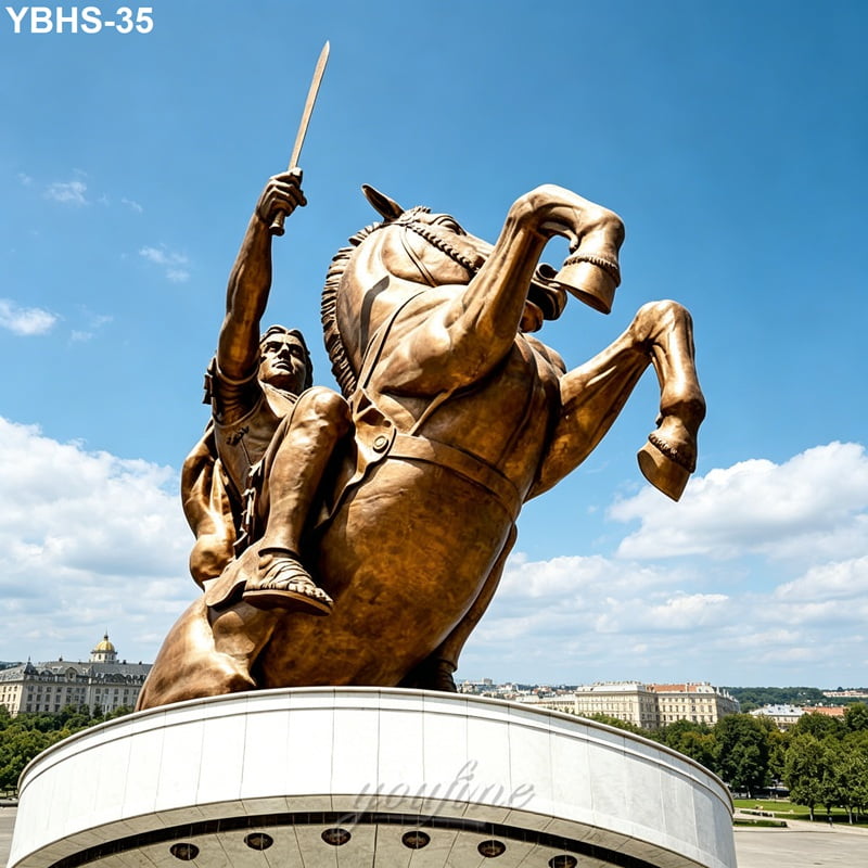 Large bronze statue of a warrior holding a sword on a rearing horse, mounted on a pedestal under a bright blue sky.