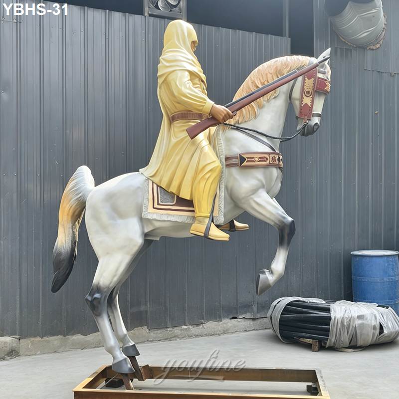 Bronze sculpture depicting a shrouded warrior holding a rifle, riding a rearing white horse adorned with intricate detailing.
