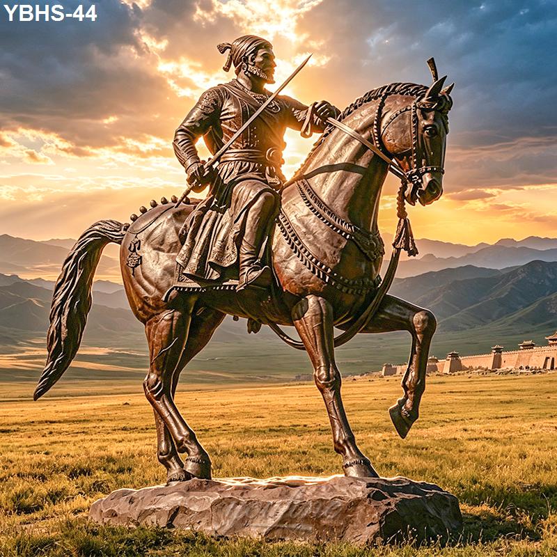 A bronze statue of a warrior on a rearing horse, holding a sword, set against a sunset landscape with mountains and open fields.