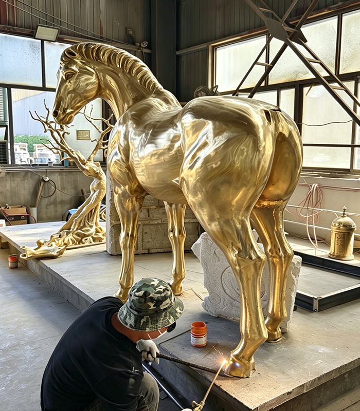 A worker is making a bronze horse sculpture