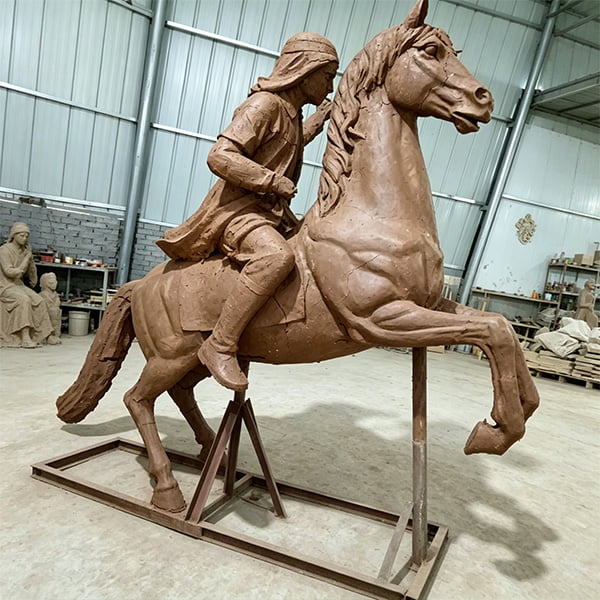 Detailed clay model of custom bronze horse sculpture being refined by master sculptor