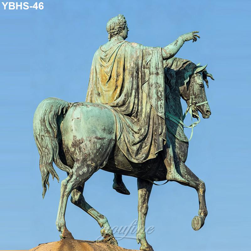 Bronze equestrian statue depicting a historical figure on horseback with detailed reins and drapery, set against a clear blue sky.