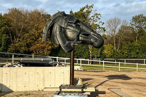 Bronze mare and foal sculpture group installed in formal garden of a French chateau