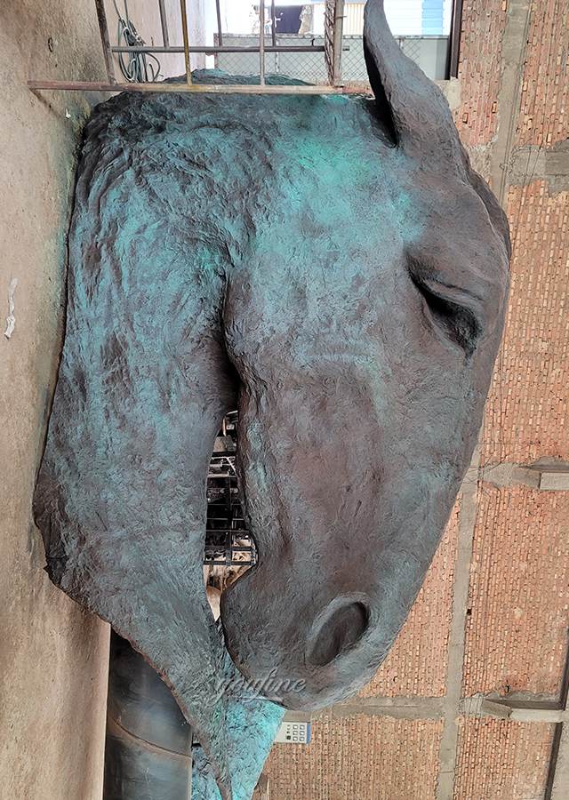 Large 5m bronze horse head sculpture in workshop