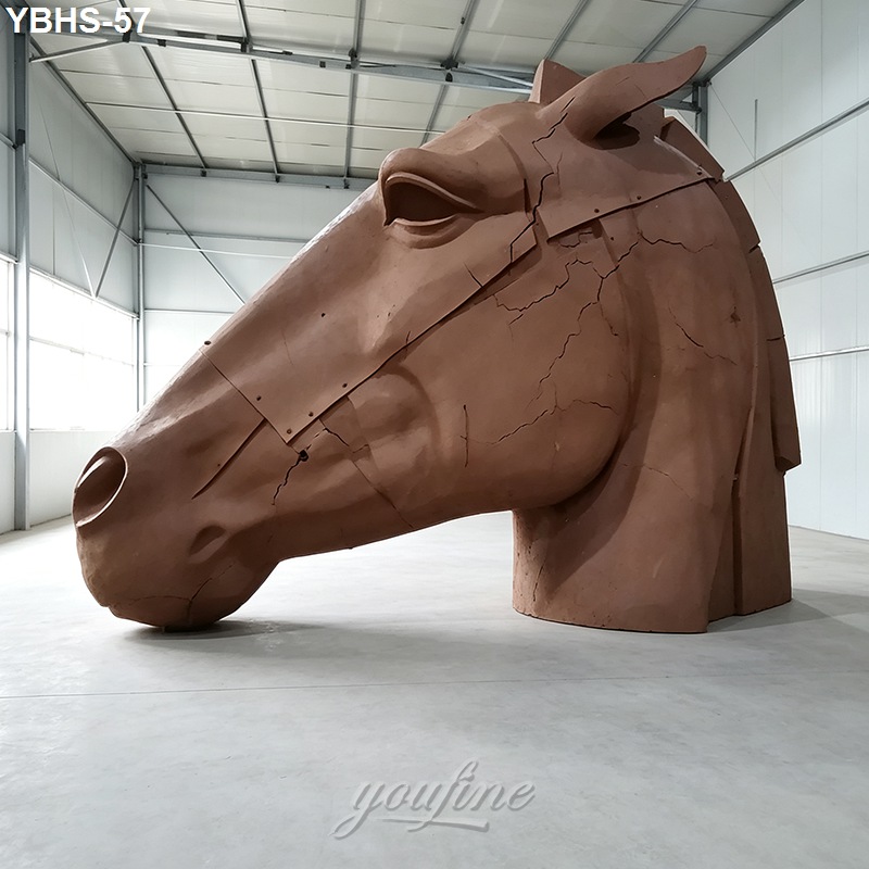 A large bronze horse head statue clay model featuring a modern design, displayed indoors in a metal-framed room.