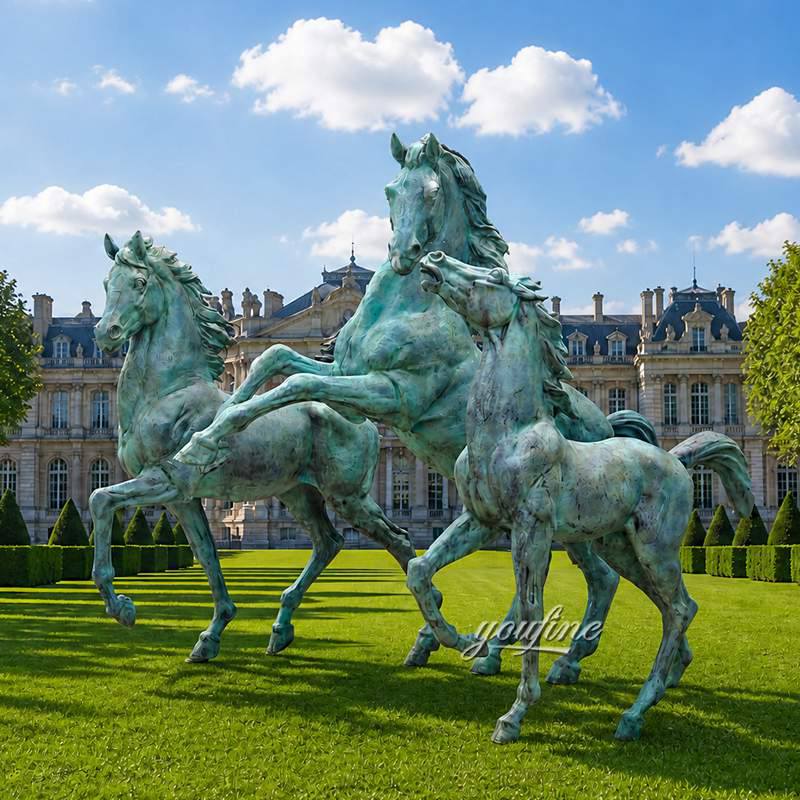 Three dynamic bronze horse sculptures in a lush green garden with a grand manor in the background under a blue sky.
